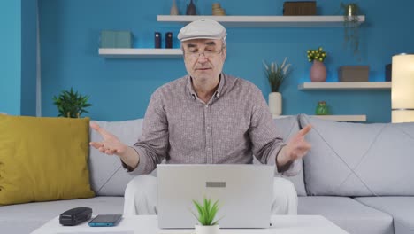 Elderly-man-looking-at-laptop-and-reacting-negatively.